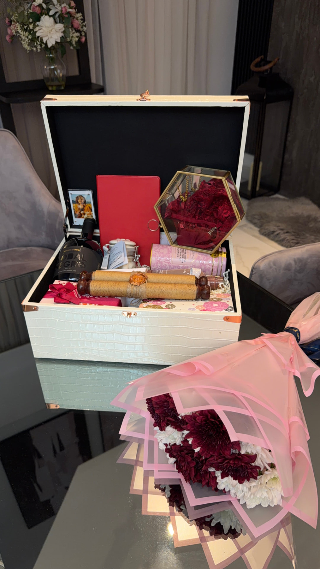 The Woman I Call Home open presentation trunk with its curated contents and rose bouquet